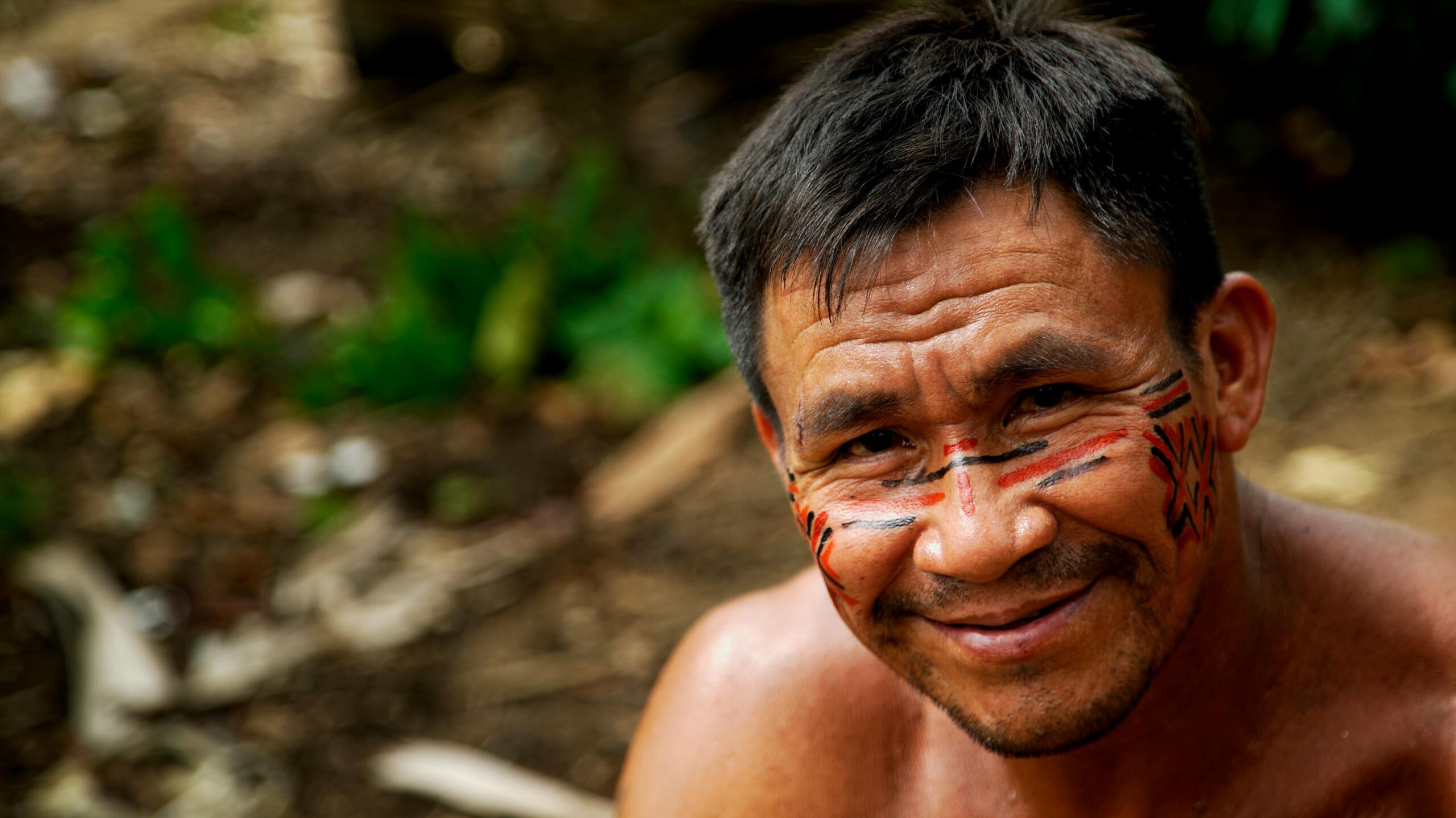 Portrait of an indigenous man in the Amazon, showcasing traditional face paint.